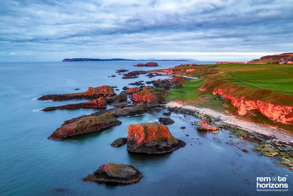 Aerial landscape photograph of the Elephant Rock, Ballintoy, at sunset.