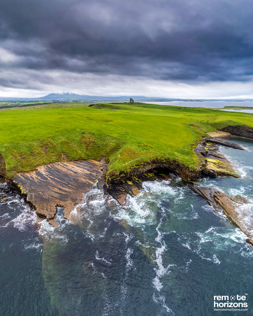 Aerial landscape photograph of Classiebawn Castle, Mullaghmore, County Sligo, Ireland.  In this landscape photograph you can see the rock formations extending under the water.