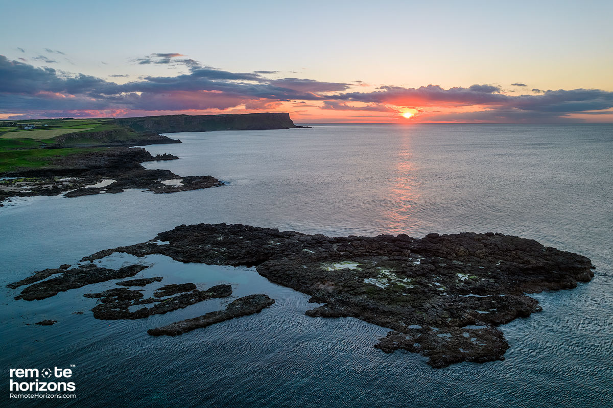 Northern Ireland aerial landscape photography of Dunseverick looking towards the Giant's Causeway at sunset.