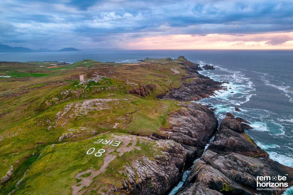 Ireland aerial landscape photography of Malin Head with the Eire 80 sign at sunset