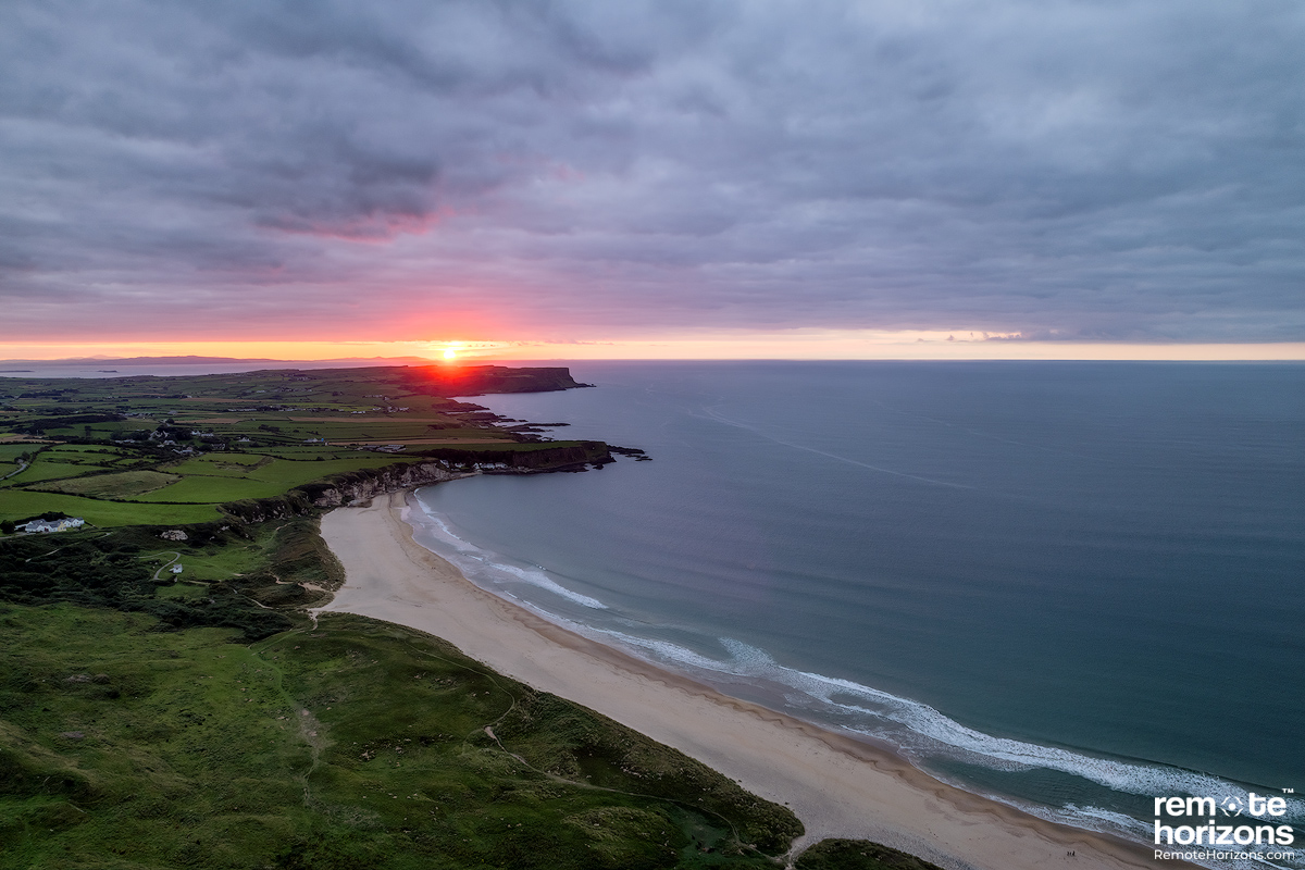 Aerial landscape photograph of White Park Bay, Northern Ireland, at sunset.